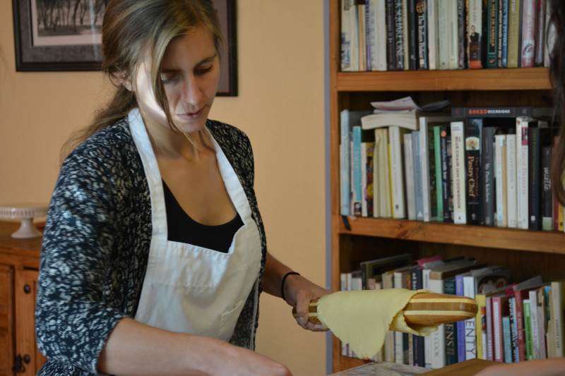 baking student preparing to roll dough on tart pan